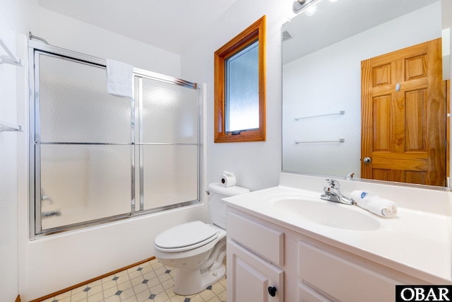 full bath with shower / bath combination with glass door, visible vents, toilet, vanity, and tile patterned floors