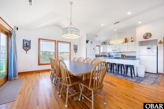 dining area featuring high vaulted ceiling, recessed lighting, visible vents, baseboards, and light wood-type flooring