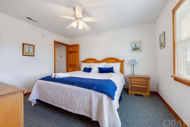 bedroom featuring ceiling fan, dark carpet, visible vents, and baseboards