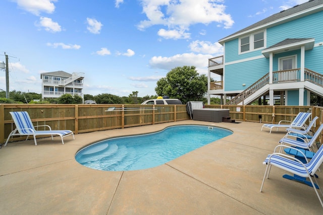 view of swimming pool featuring a fenced in pool, fence, stairs, and a patio area