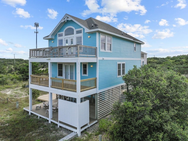 back of property featuring a balcony