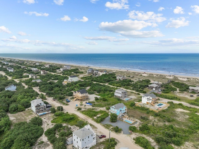 drone / aerial view featuring a water view and a view of the beach