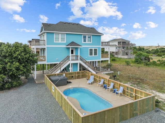 view of swimming pool with a patio area, stairway, a fenced in pool, and fence