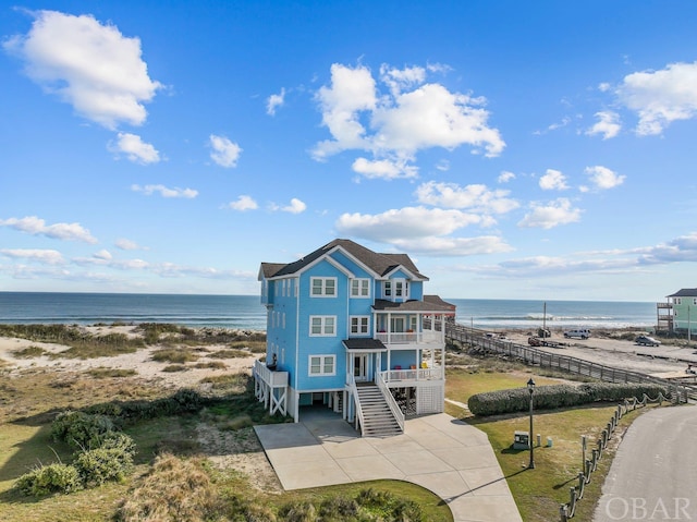 property view of water with stairway and a beach view