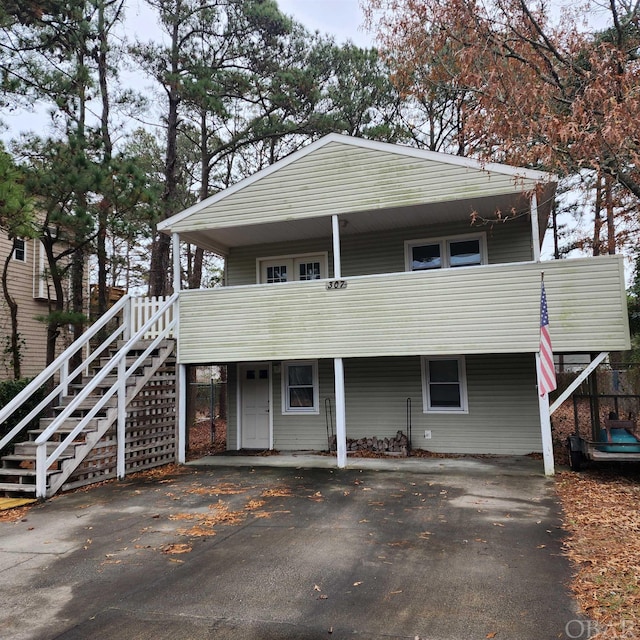 view of front of house featuring aphalt driveway and stairway