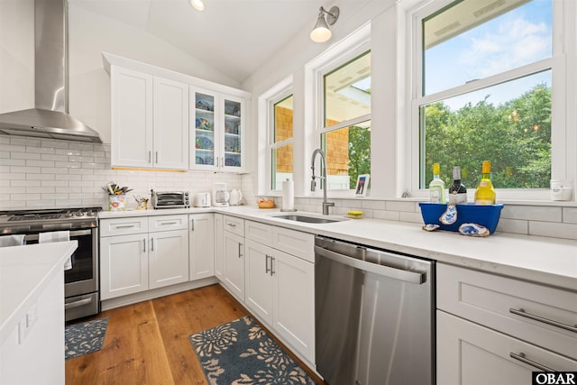 197 Wax Myrtle Trl Lot # 15R, Southern Shores, NC 27949 - kitchen featuring stainless steel appliances, wall chimney exhaust hood, a sink, lofted ceiling, and decorative backsplash
