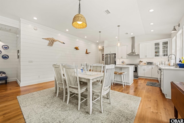 197 Wax Myrtle Trl Lot # 15R, Southern Shores, NC 27949 - dining room featuring vaulted ceiling, light wood-style flooring, recessed lighting, and wood walls