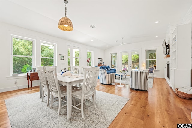 197 Wax Myrtle Trl Lot # 15R, Southern Shores, NC 27949 - dining space featuring light wood-style flooring, a fireplace, lofted ceiling, baseboards, and french doors