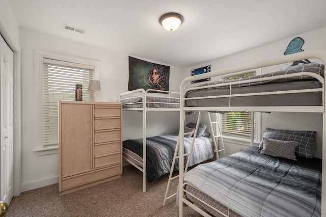 bedroom with carpet floors, baseboards, and visible vents