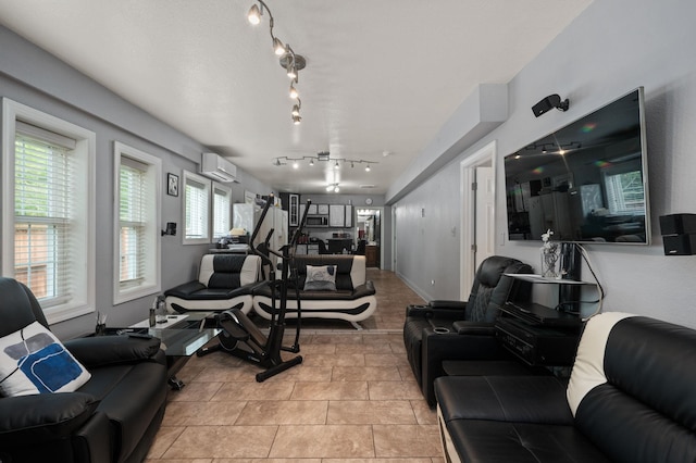 gym with light tile patterned floors, an AC wall unit, and baseboards