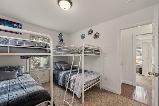 bedroom featuring carpet flooring and baseboards