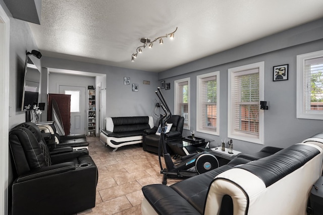 living room featuring a textured ceiling and light tile patterned flooring