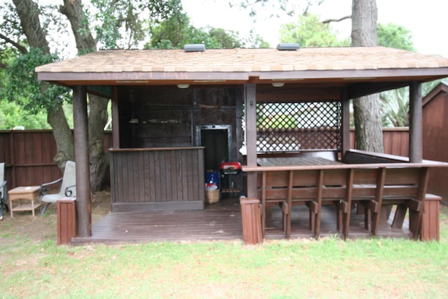 deck with fence and outdoor dry bar