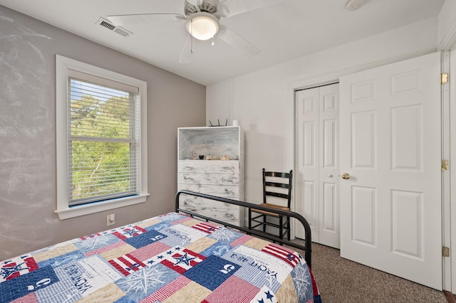 bedroom featuring ceiling fan, a closet, dark carpet, and visible vents