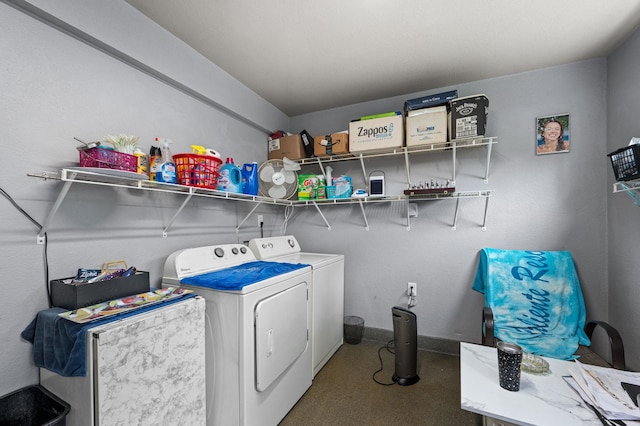 laundry area featuring washing machine and dryer, laundry area, and baseboards