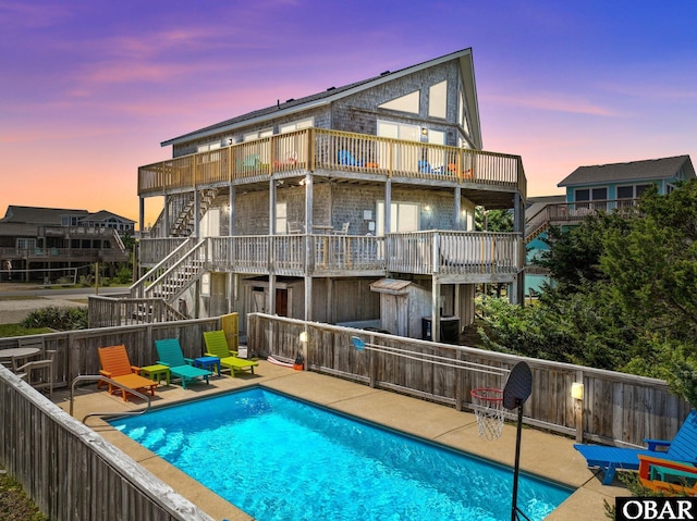 25263 Sea Isle Hills Dr Lot # 4-1, Waves, NC 27982 - back of property at dusk featuring stairway, a wooden deck, and a patio area