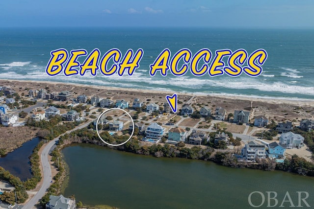 bird's eye view with a beach view, a water view, and a residential view