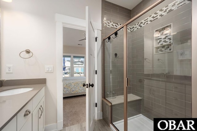 1303 W First St Lot 63, Kill Devil Hills, NC 27948 - ensuite bathroom featuring a shower stall, vanity, baseboards, and wood finished floors