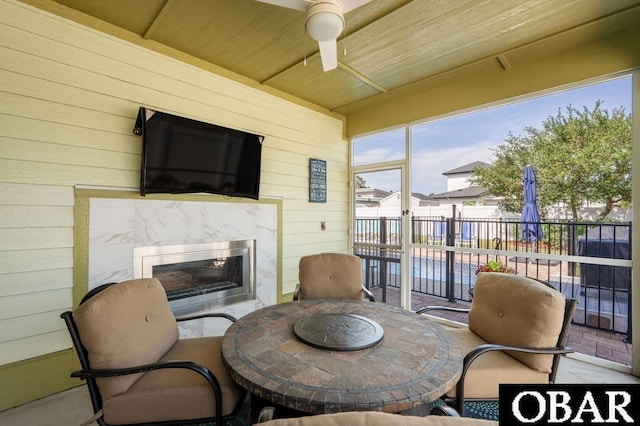 1303 W First St Lot 63, Kill Devil Hills, NC 27948 - sunroom / solarium featuring a high end fireplace, ceiling fan, and outdoor dining area