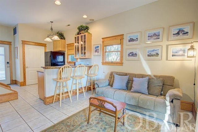 living room featuring recessed lighting, visible vents, baseboards, and light tile patterned floors