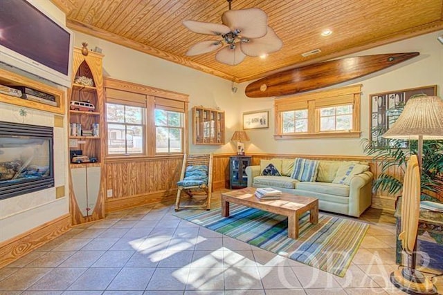 living room featuring wooden ceiling, light tile patterned floors, and a wealth of natural light