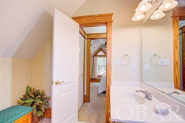 ensuite bathroom with vaulted ceiling, an inviting chandelier, vanity, and ensuite bathroom