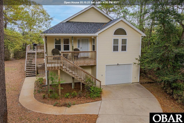 view of front facade with a garage, stairs, concrete driveway, a porch, and roof with shingles
