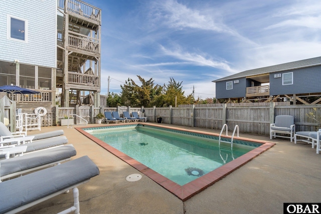 community pool featuring a patio area and fence