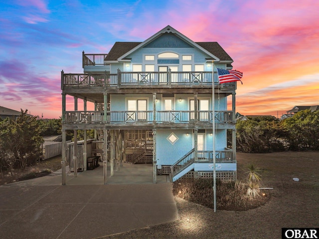 view of front of property with a carport, driveway, and a balcony