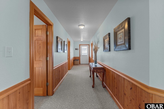 corridor with a wainscoted wall and wood walls