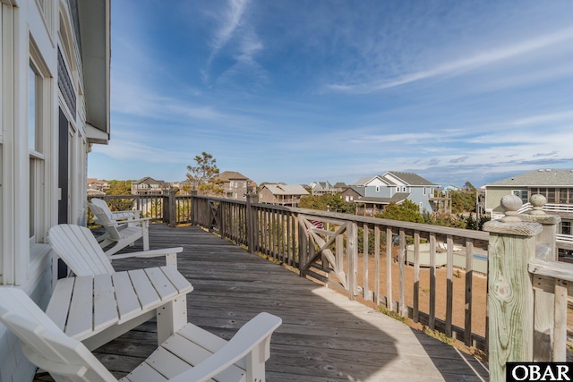 wooden terrace with a residential view