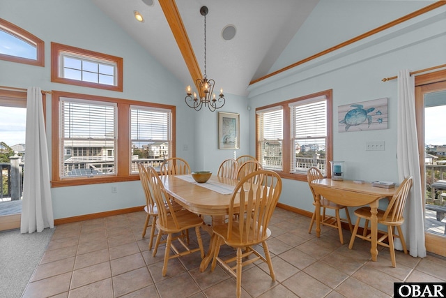 dining area featuring a notable chandelier, baseboards, light tile patterned floors, and high vaulted ceiling