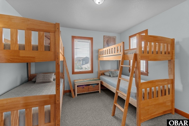 bedroom featuring multiple windows, baseboards, and carpet floors