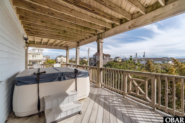 wooden terrace featuring a hot tub