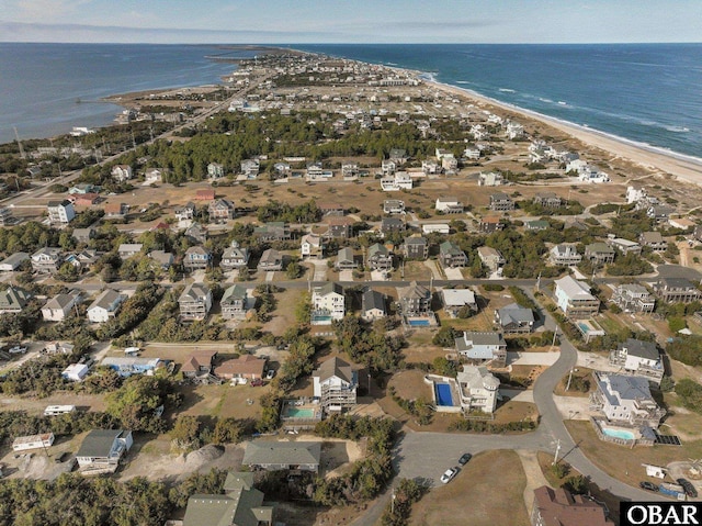 aerial view featuring a residential view, a view of the beach, and a water view