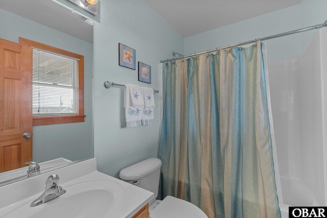 bathroom with shower / tub combo, toilet, and vanity