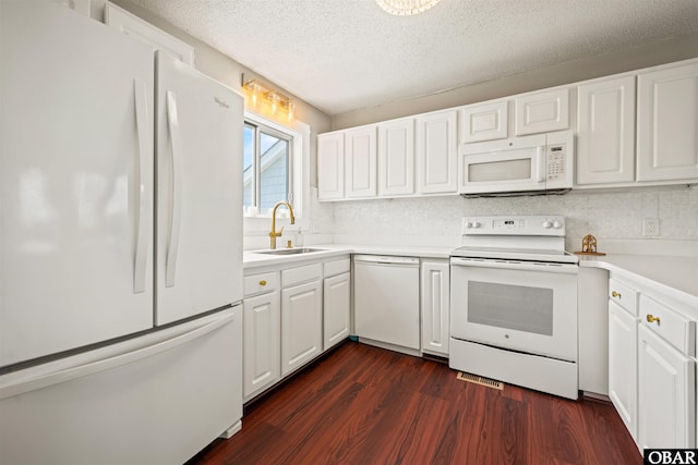 614-B Sea Oats Ct Lot # 6, Corolla, NC 27927 - kitchen featuring white appliances, dark wood-style floors, white cabinetry, light countertops, and a textured ceiling