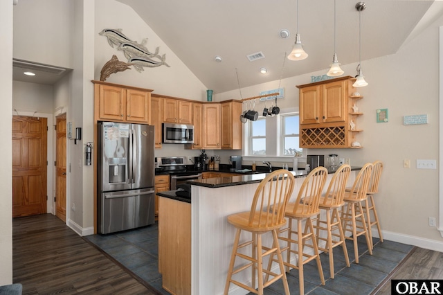 56432 NC-12 Hwy Lot 1, Hatteras, NC 27943 - kitchen featuring stainless steel appliances, dark wood finished floors, a kitchen bar, dark countertops, and hanging light fixtures