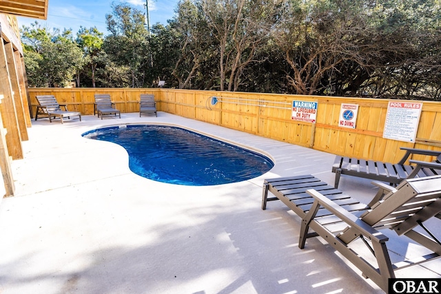 pool featuring fence and a patio