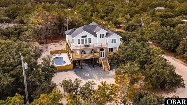 drone / aerial view featuring a wooded view