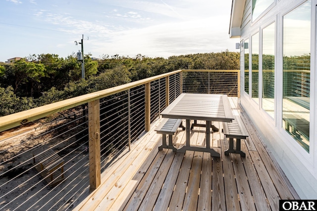 wooden terrace with outdoor dining space