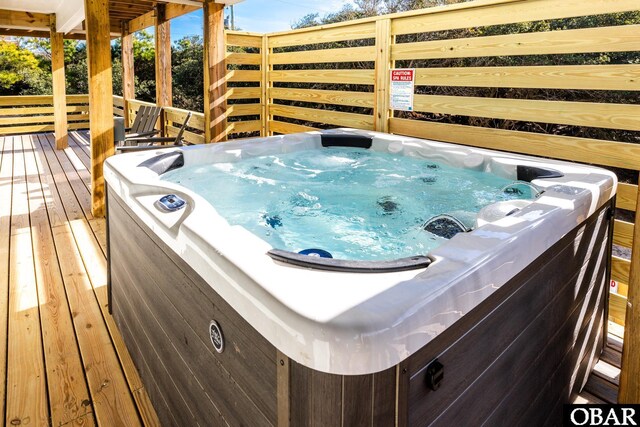 wooden deck featuring a hot tub