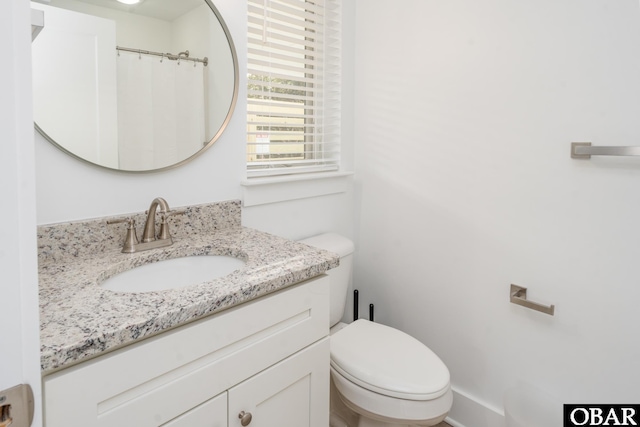 full bathroom with toilet and vanity