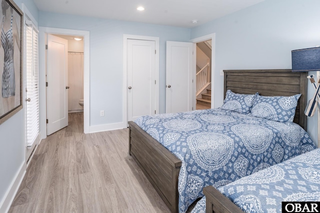 bedroom featuring light wood-style flooring and baseboards