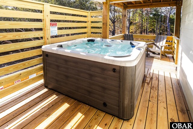 wooden deck with a hot tub