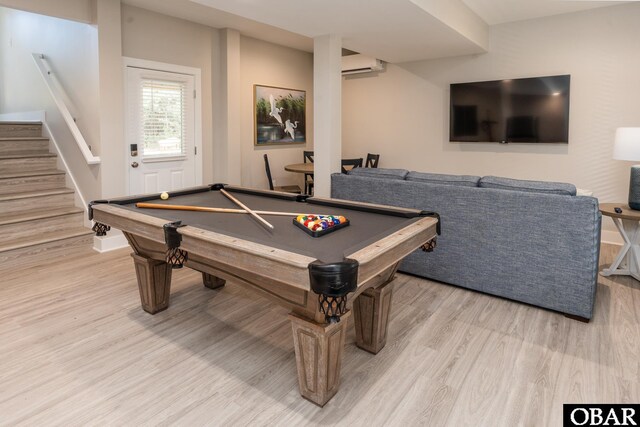 playroom featuring a wall unit AC, billiards, and light wood-style flooring