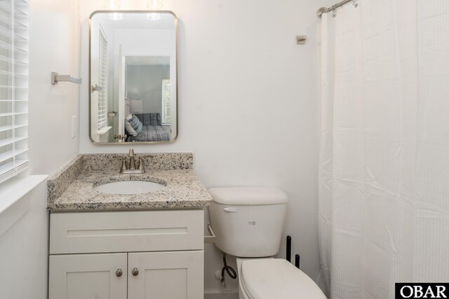 bathroom featuring toilet and vanity