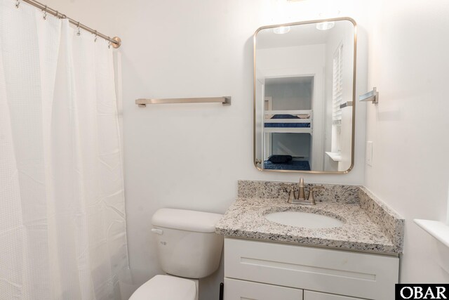 full bathroom featuring vanity and toilet