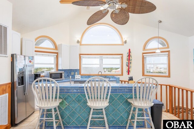 23212 Sea Oats Dr Lot 18, Rodanthe, NC 27968 - kitchen with appliances with stainless steel finishes, light tile patterned flooring, and high vaulted ceiling