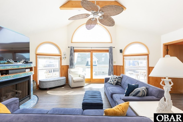 23212 Sea Oats Dr Lot 18, Rodanthe, NC 27968 - living room featuring a fireplace, wood walls, a wainscoted wall, a ceiling fan, and wood finished floors
